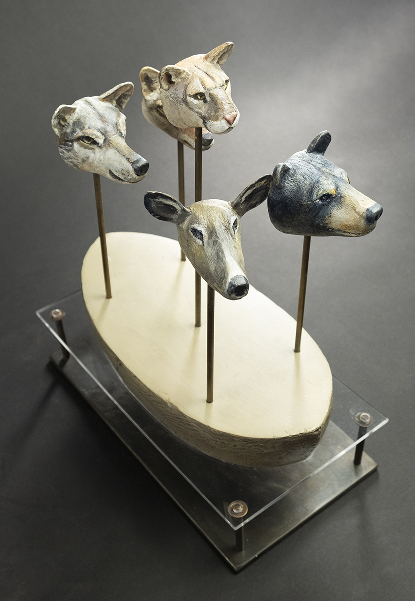 Boat of four animal head totems: wolf/coyote, cougar, deer, and bear