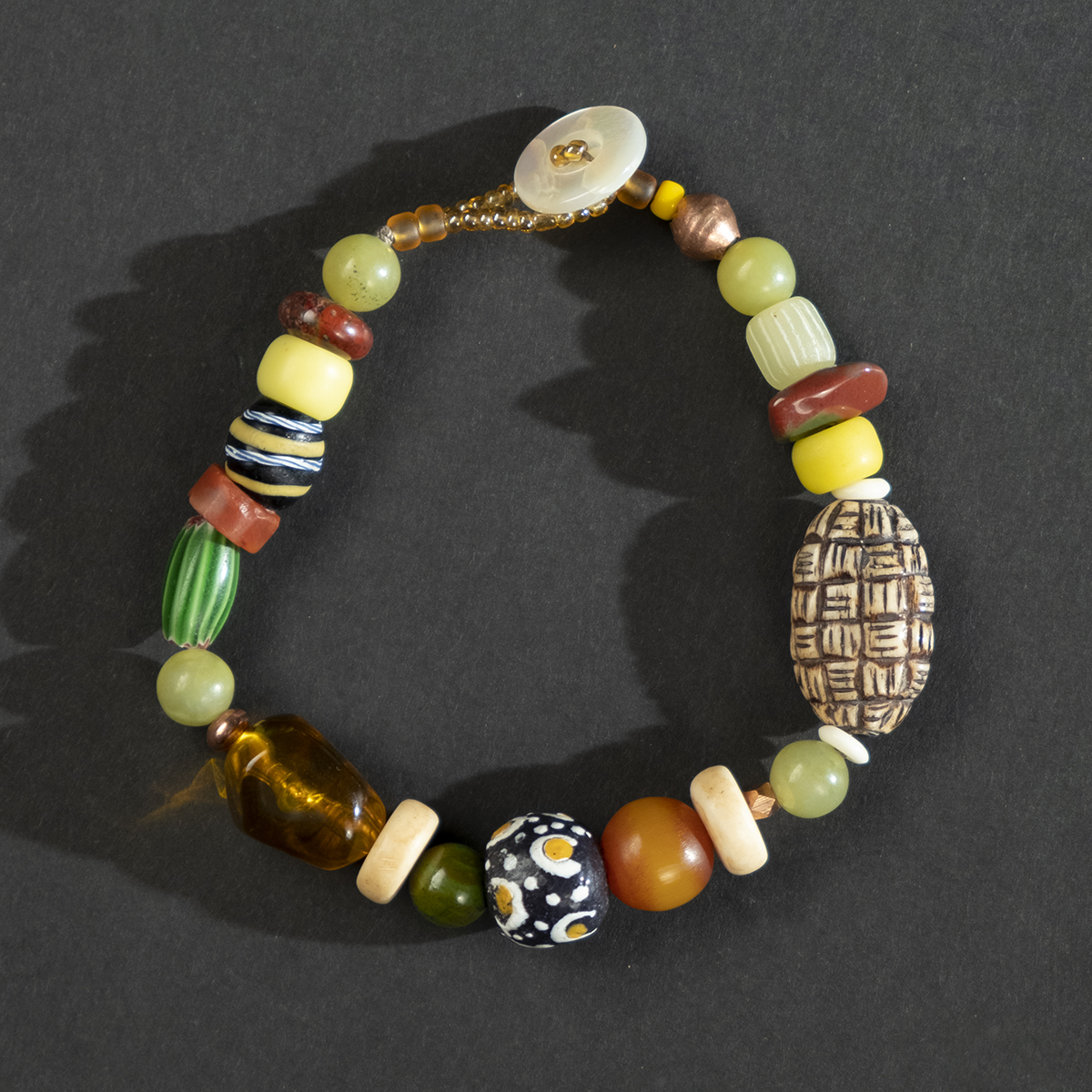 white Buddha juju trade bead bracelet with rare ancient bronze coin